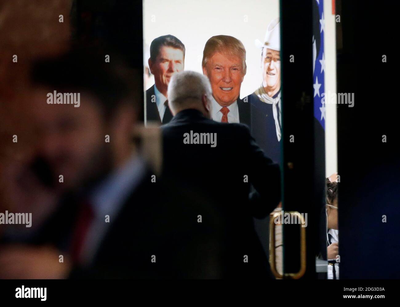 A man enters a room decorated with a Ronald Regan, Donald Trump and John Wayne cardboard cutout / posters in Trump Tower on January 11, 2017 in New York City. U.S. President Elect Donald Trump is still holding meetings upstairs at Trump Tower as he continues to fill in key positions in his new administration. Photo by John Angelillo/UPI Stock Photo