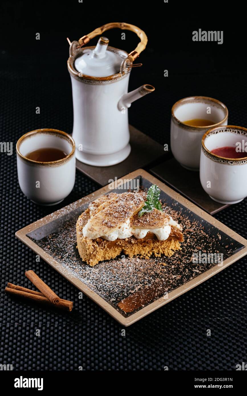 various desserts with tea on a black background Stock Photo