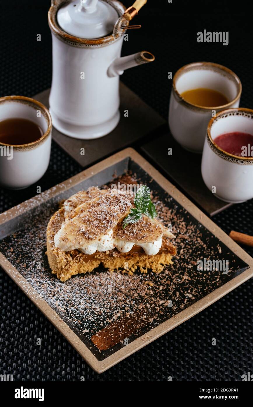 various desserts with tea on a black background Stock Photo
