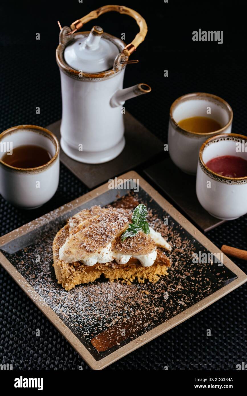 various desserts with tea on a black background Stock Photo