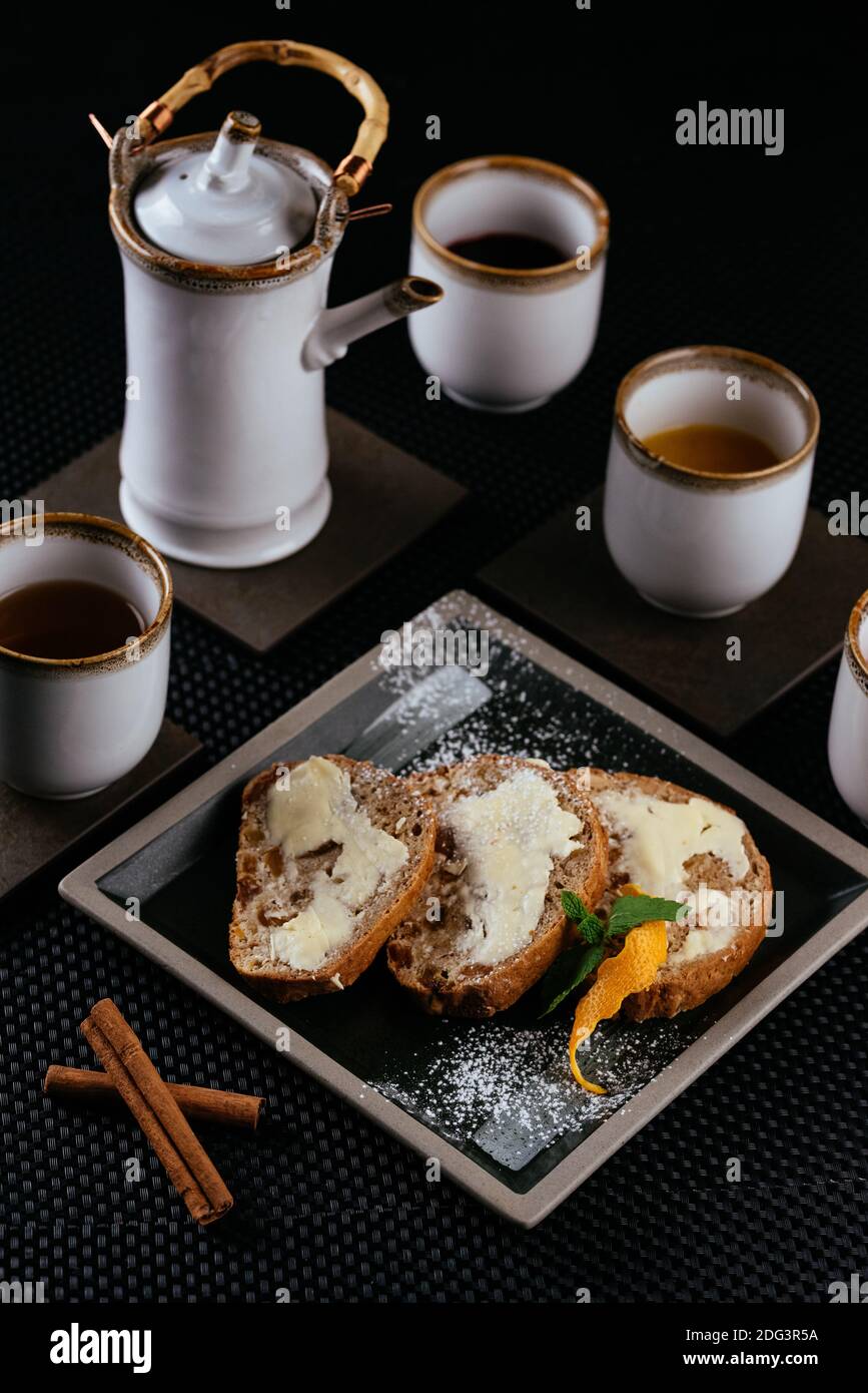 various desserts with tea on a black background Stock Photo