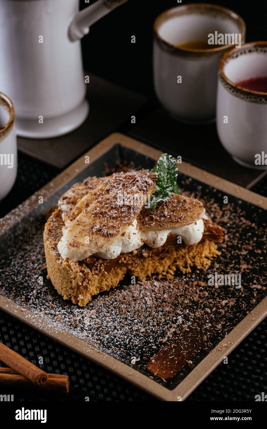 various desserts with tea on a black background Stock Photo