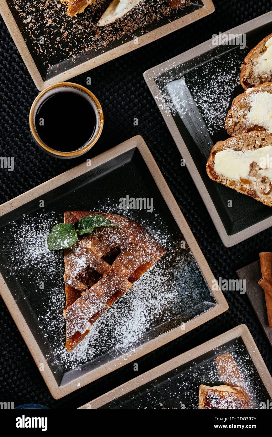 various desserts with tea on a black background Stock Photo