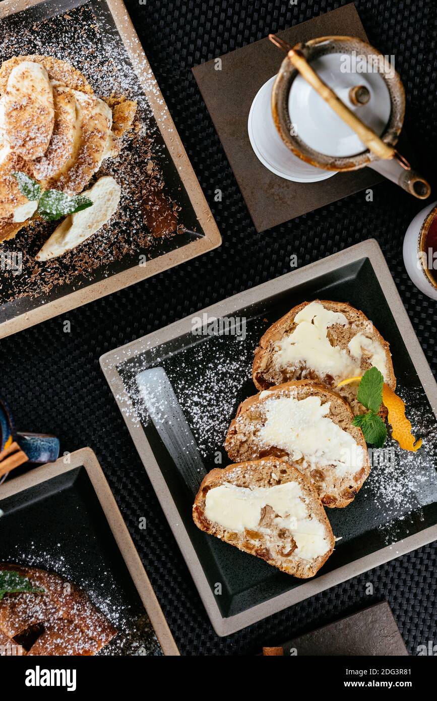 various desserts with tea on a black background Stock Photo