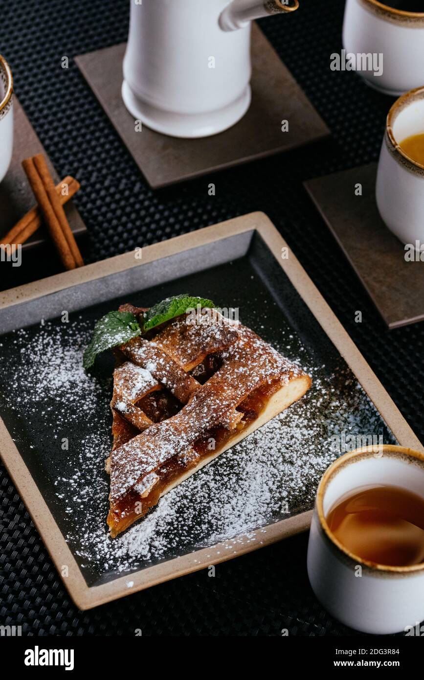 various desserts with tea on a black background Stock Photo