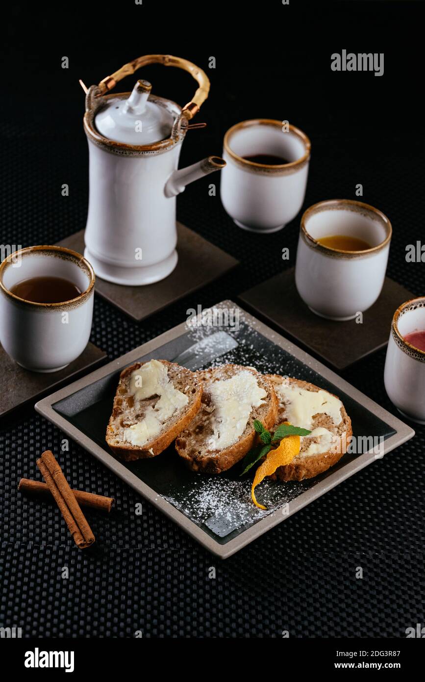 various desserts with tea on a black background Stock Photo