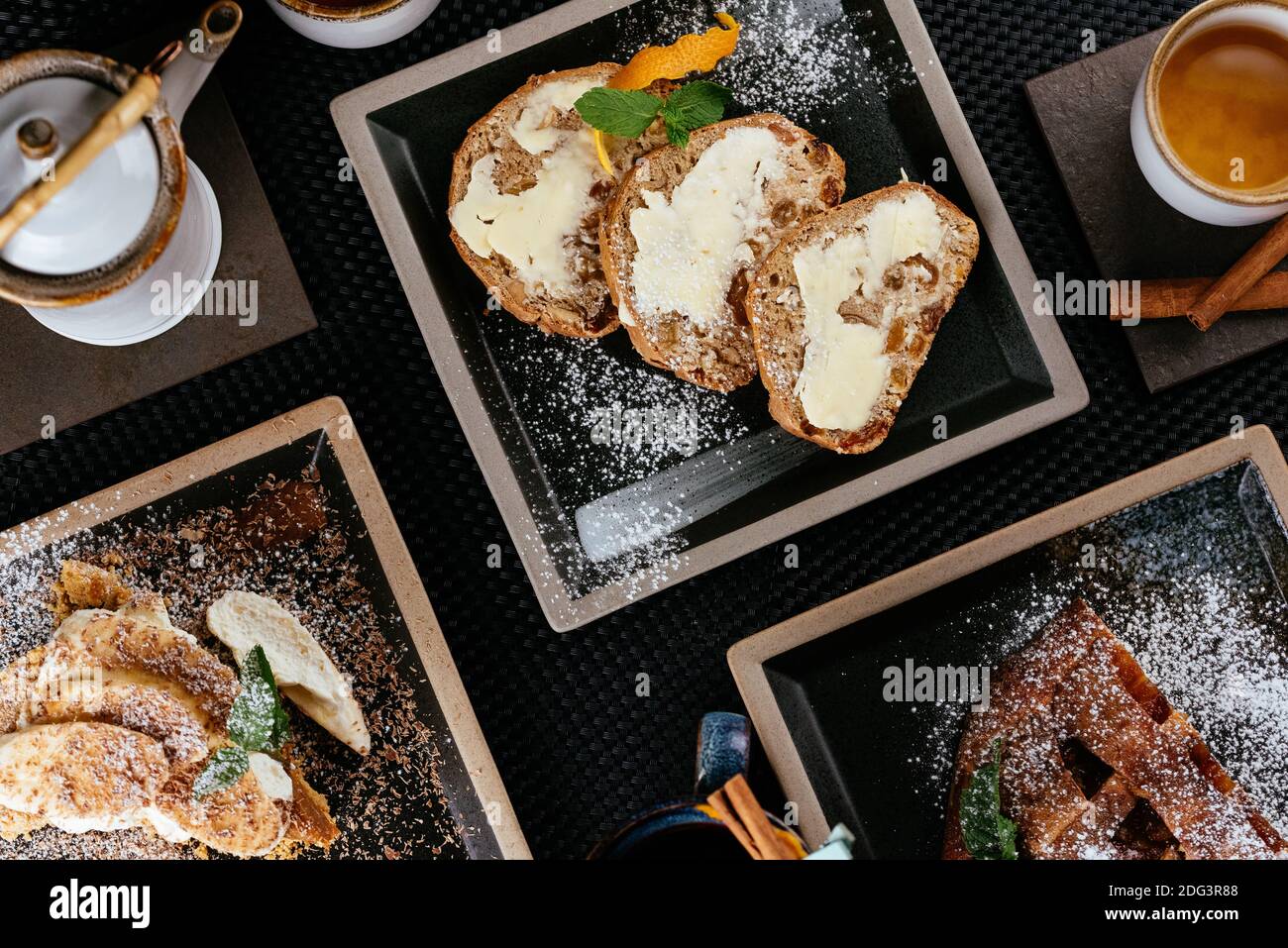 various desserts with tea on a black background Stock Photo
