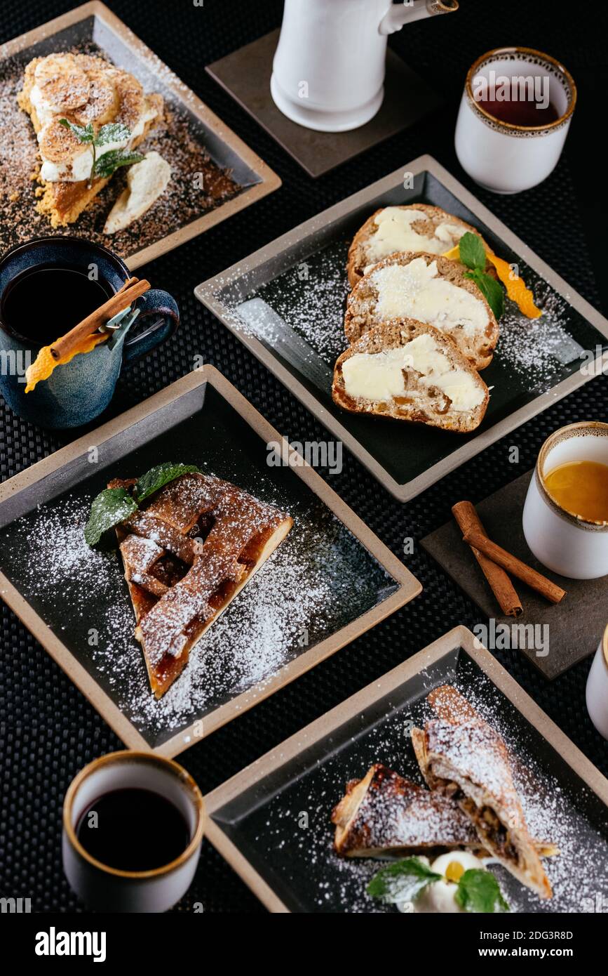 various desserts with tea on a black background Stock Photo