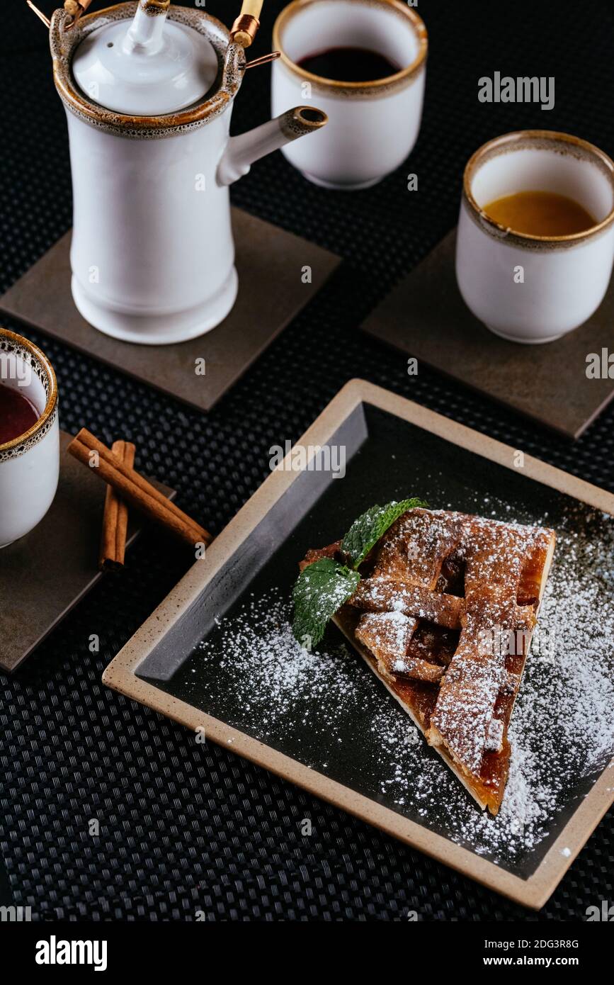 various desserts with tea on a black background Stock Photo