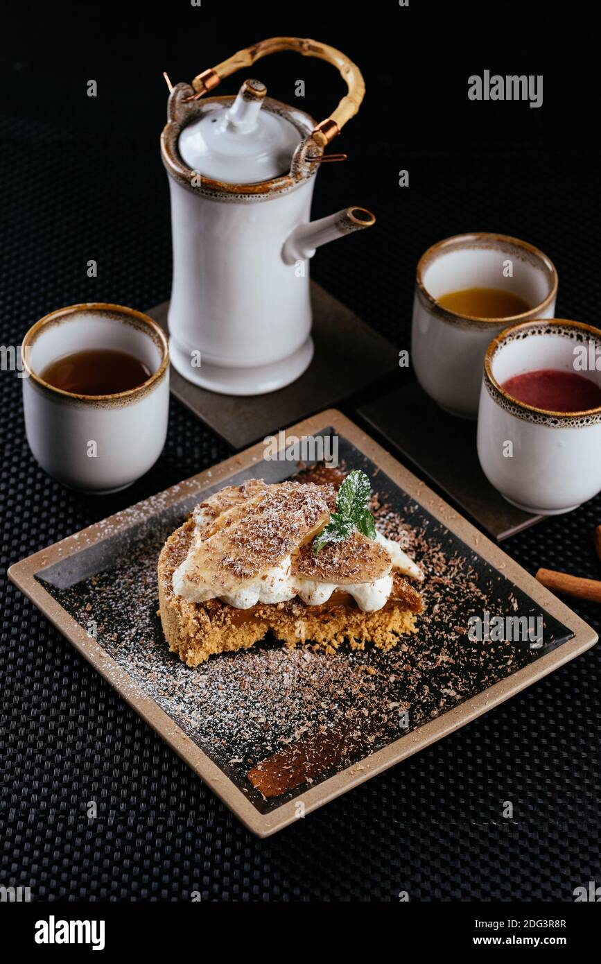 various desserts with tea on a black background Stock Photo