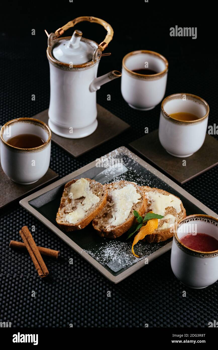 various desserts with tea on a black background Stock Photo