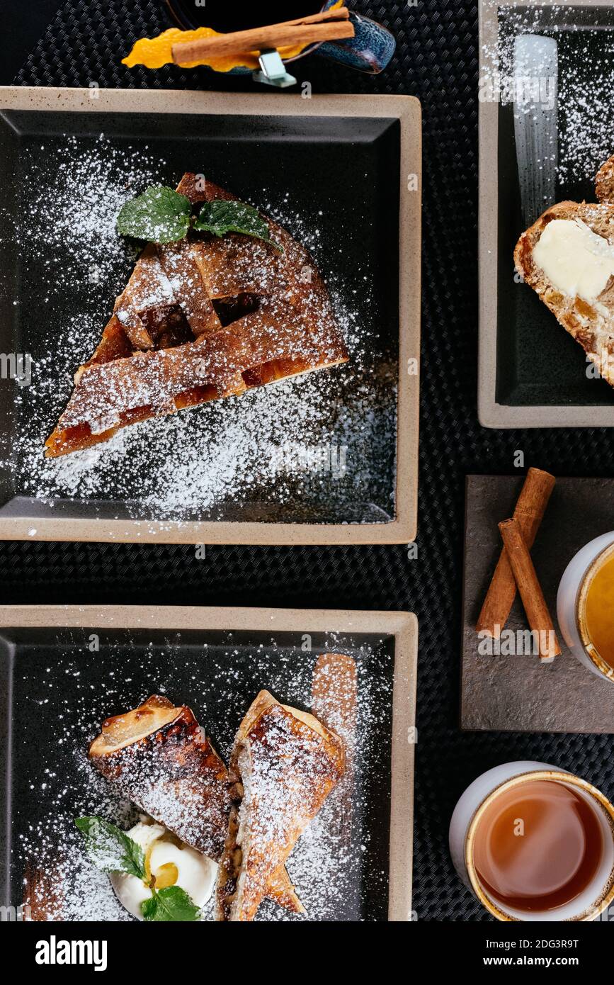 various desserts with tea on a black background Stock Photo