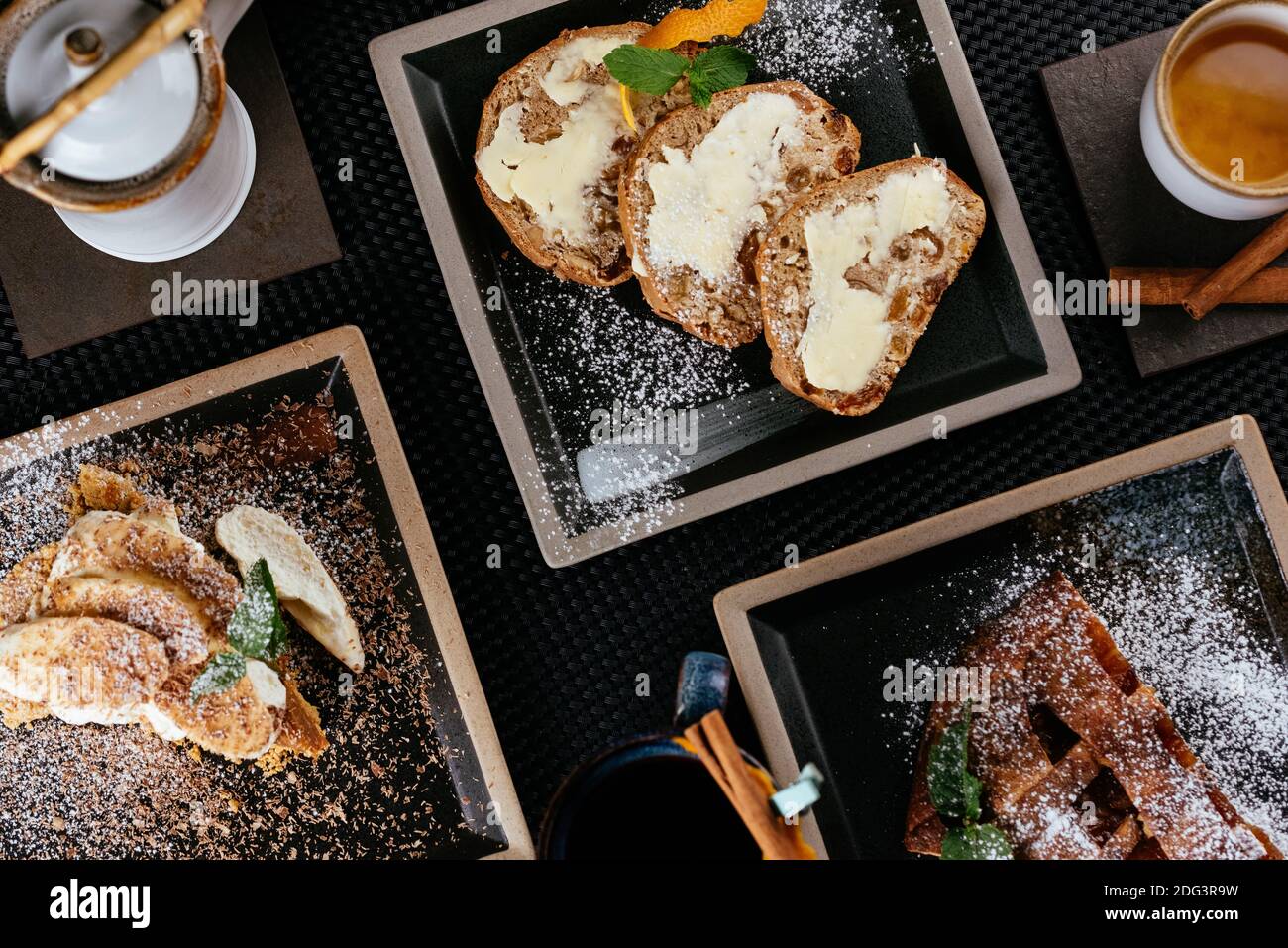 various desserts with tea on a black background Stock Photo