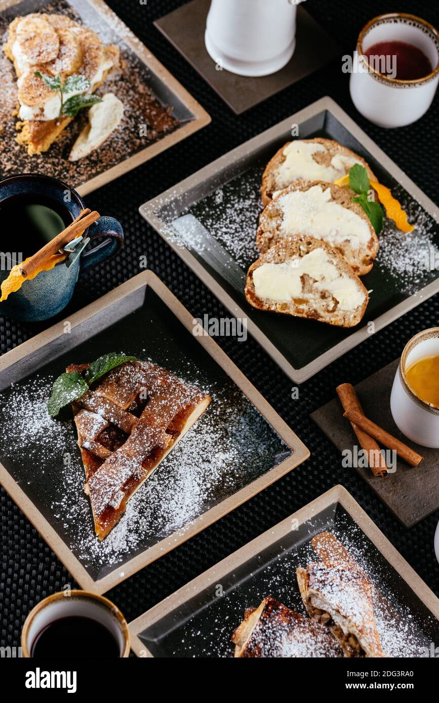 various desserts with tea on a black background Stock Photo