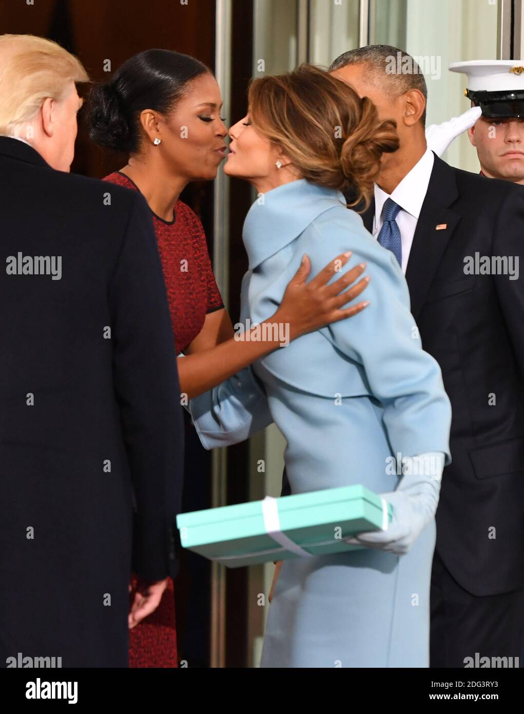 First Lady Michelle Obama kisses Melania Trump as the President and  President-elect look on at the White House before the inauguration on  January 20, 2017 in Washington, D.C. Trump becomes the 45th