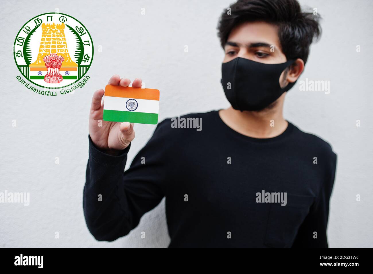 Indian man wear all black and face mask, hold India flag in hand