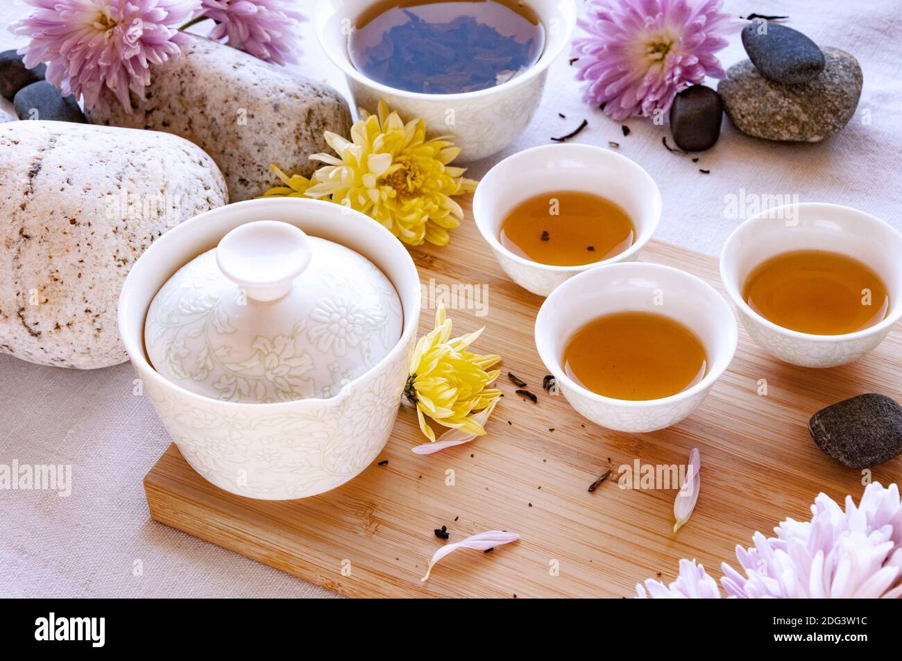 Chinese white tea cups with black tea on a bamboo board, beautiful