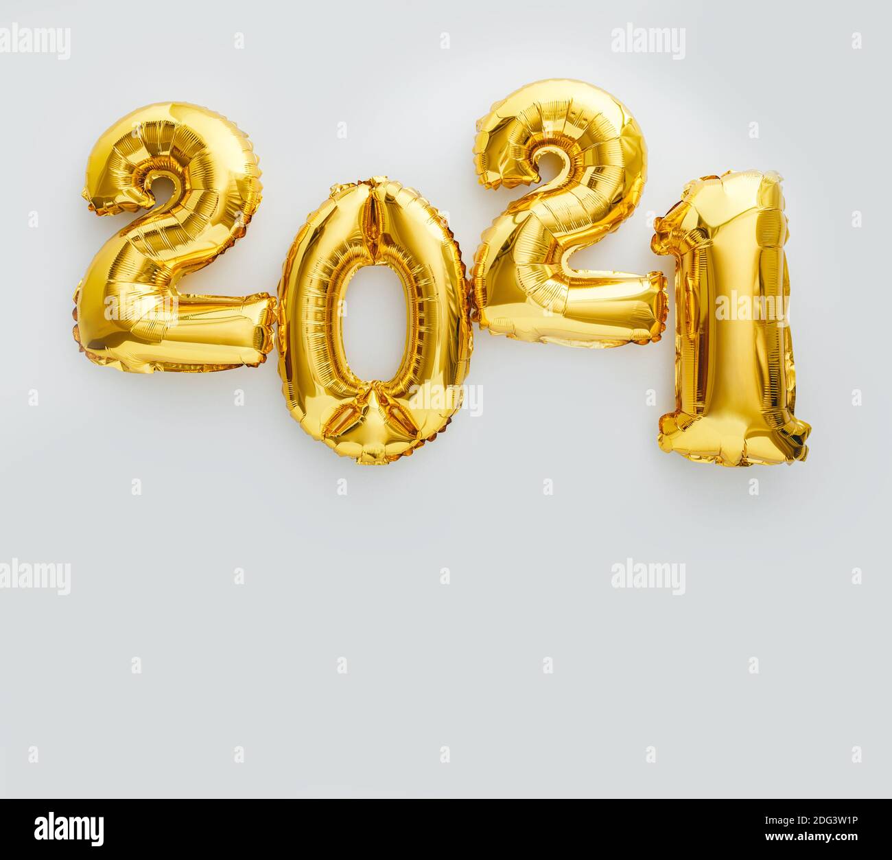 2021 balloon text on white background. Happy New year eve invitation with Christmas gold foil balloons 2021. Square flat lay with copy space Stock Photo