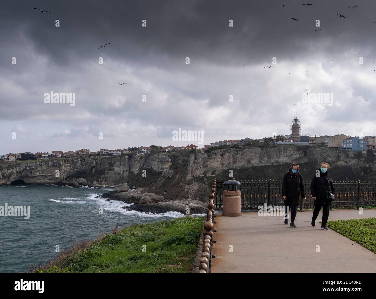 Sile, Turkey. 7th Dec, 2020. People take a walk at the seaside in Sile, a small fishing town some 70 km from Istanbul, Turkey, on Dec. 7, 2020. The concerns with the COVID-19 pandemic are causing more and more residents in Turkey's largest city Istanbul to move to the city's remote seaside districts along the shores of the Black Sea and the Marmara Sea. Credit: Osman Orsal/Xinhua/Alamy Live News Stock Photo