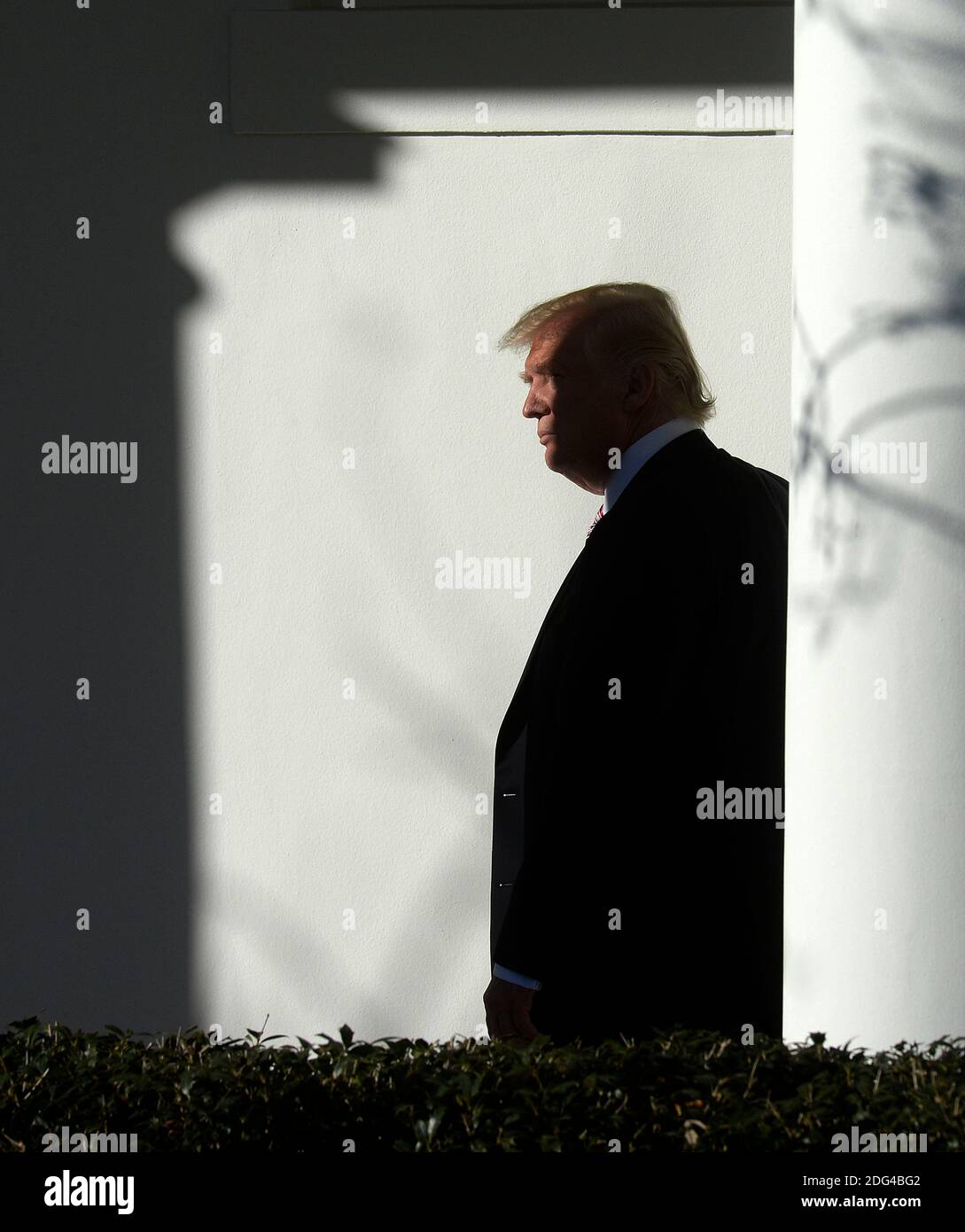 US President Donald Trump walks back to the Oval Office of the White ...