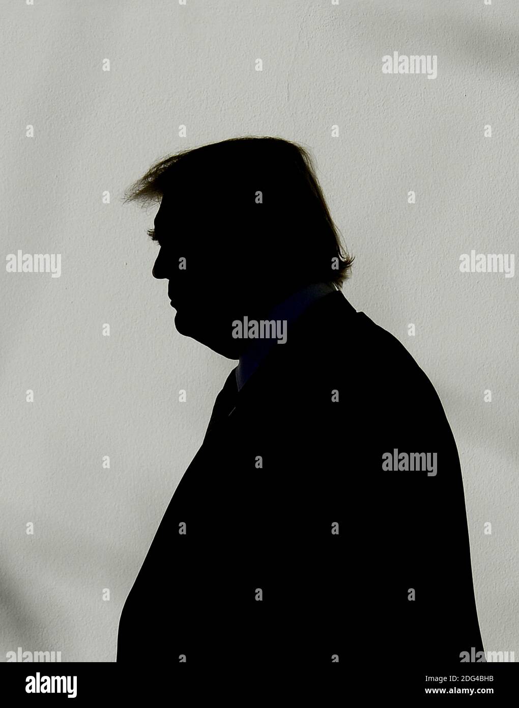 US President Donald Trump walks back to the Oval Office of the White ...