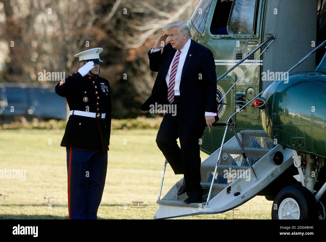 US President Donald Trump walks back to the Oval Office of the White ...