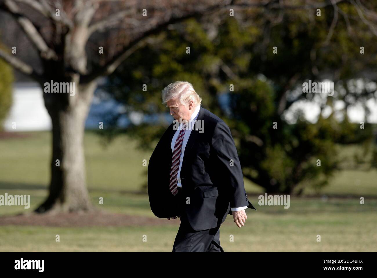 US President Donald Trump walks back to the Oval Office of the White ...