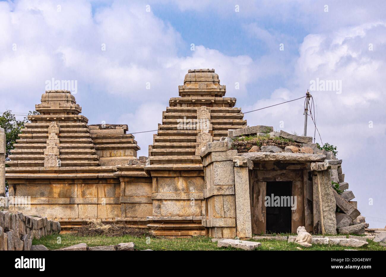 Hampi, Karnataka, India - November 4, 2013: Virupaksha Temple complex. Closeup of beige stone ruinous buildings with pyramidical towers above complex Stock Photo