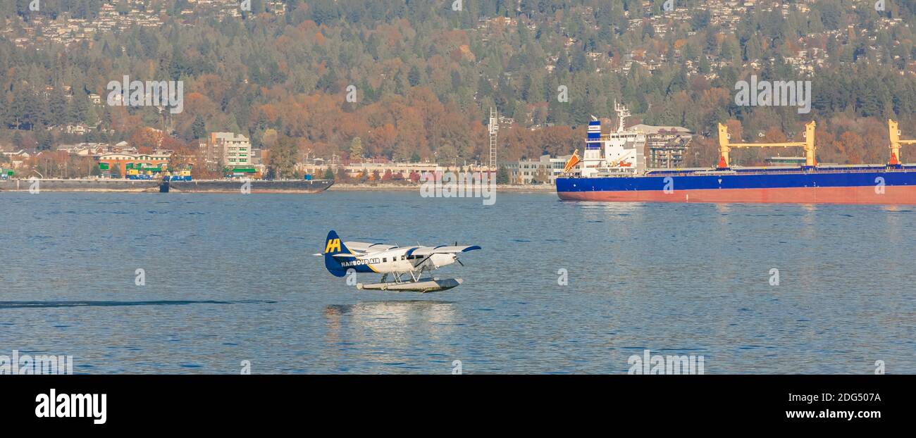 Beautiful landscape view of a Harbour air float plane taking off harbor in a background of the Richmond city, BC/Canada-October 30,2020. Panorama. Stock Photo