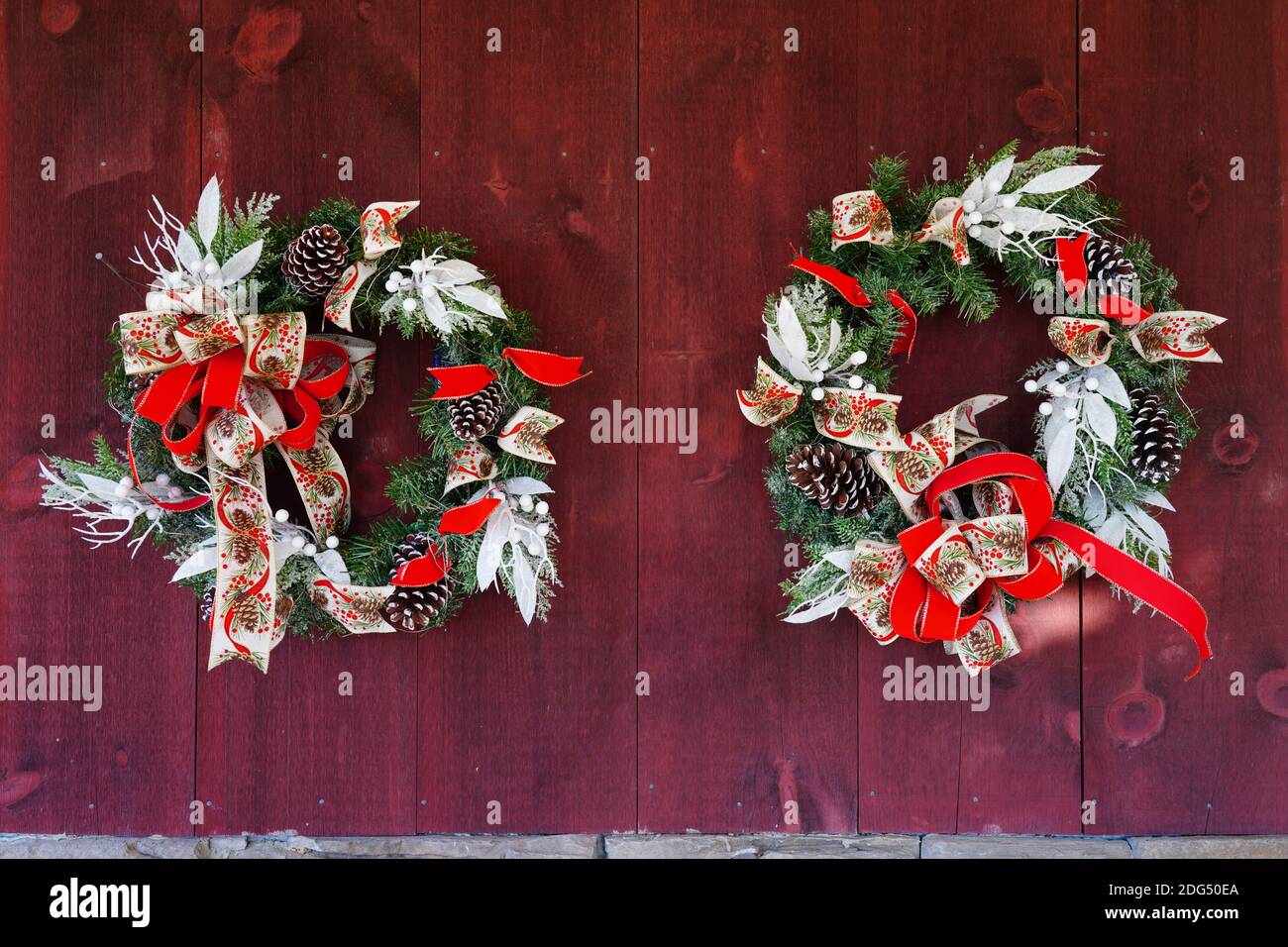 Christmas holiday pine wreath with pinecones and colorful ribbon bow on ...