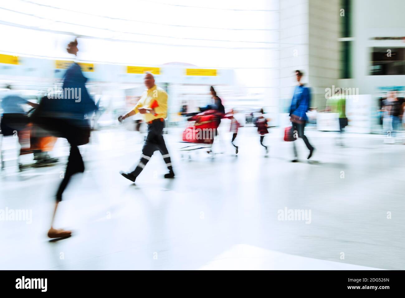 Walking crowd in the airport hall in motion blur Stock Photo