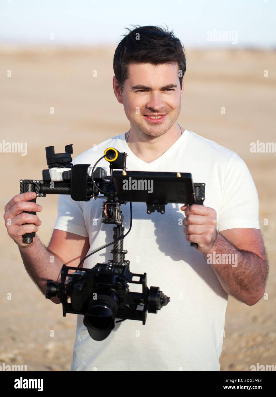 Smiling man with steadicam equipment outdoor Stock Photo