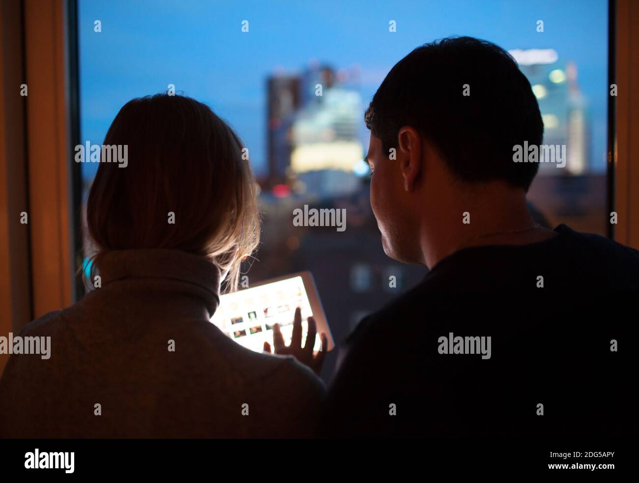 Couple Using Tablet PC in the Evening Stock Photo