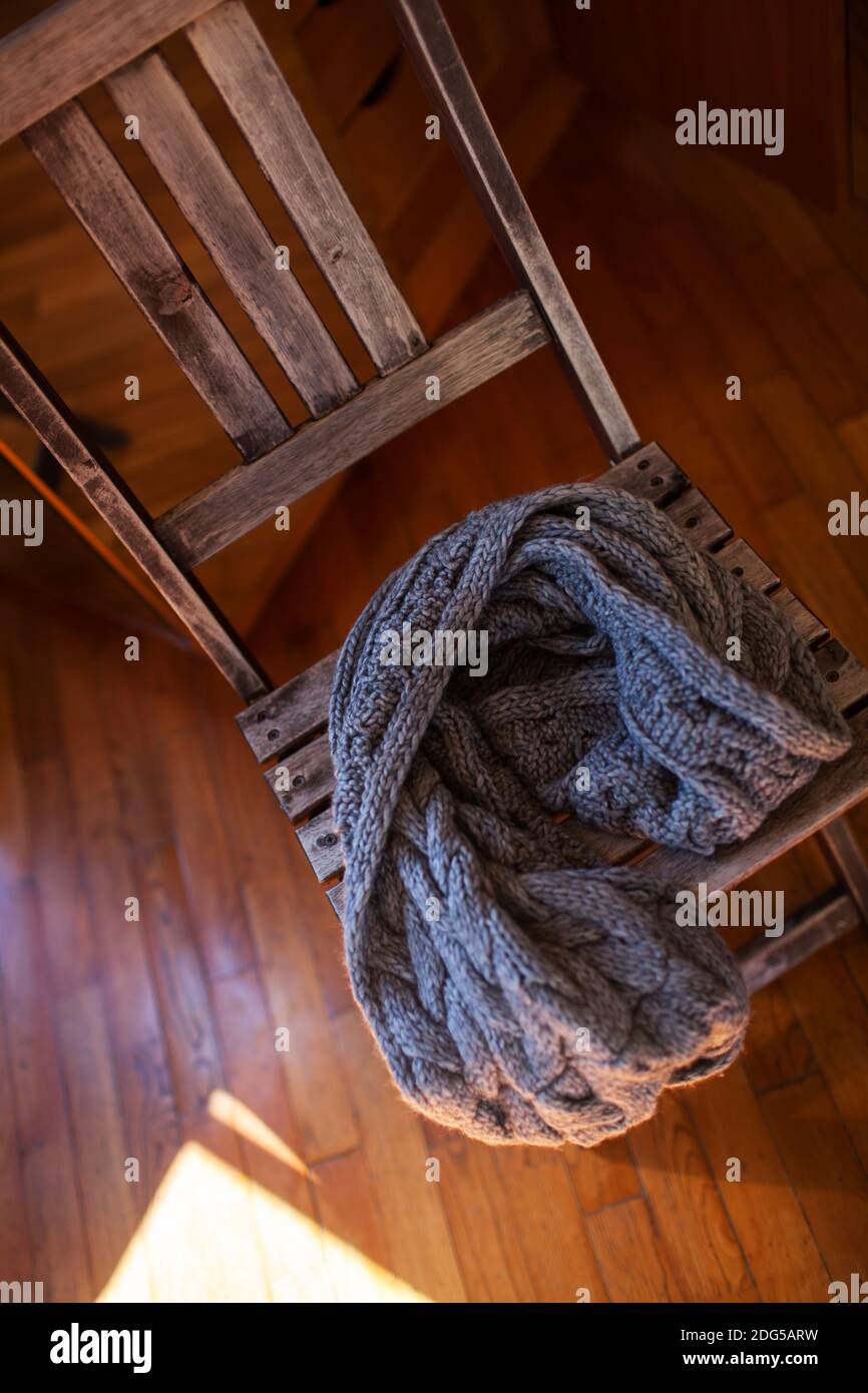 Woollen scarf lying on wooden chair Stock Photo