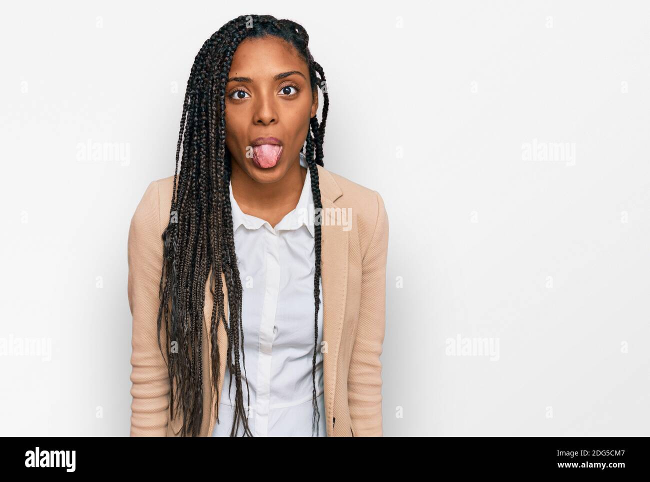 African american woman wearing business jacket sticking tongue out ...