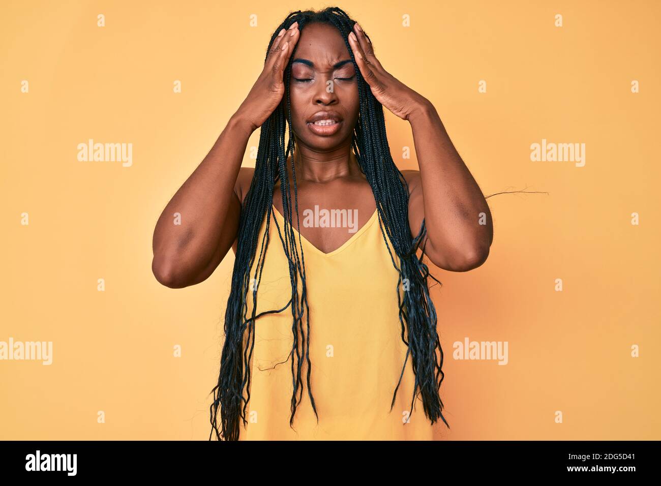 African american woman with braids wearing casual clothes with hand on ...