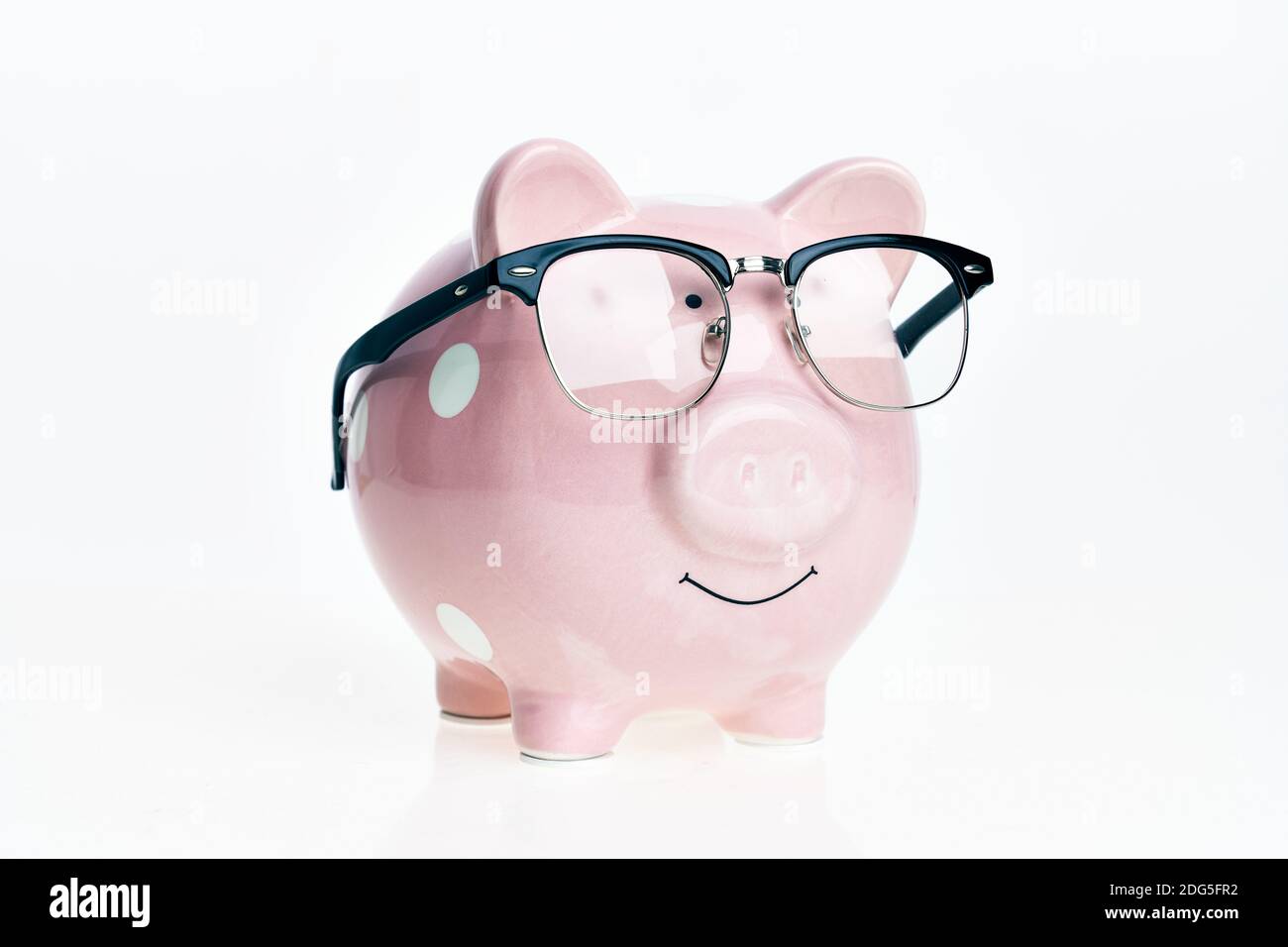 Funny piggy bank with glasses over isolated white background Stock ...
