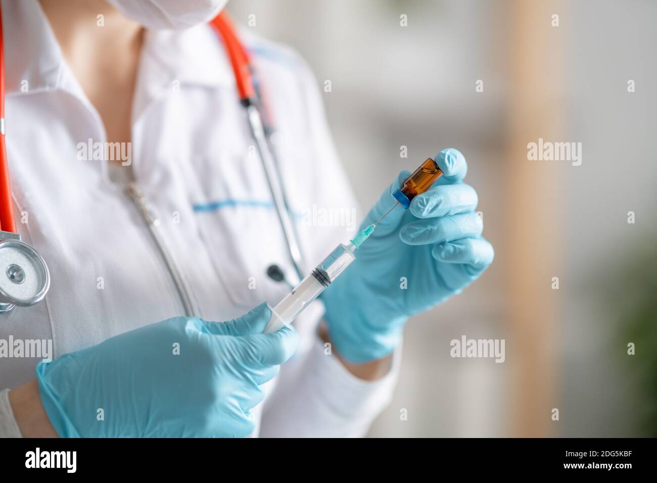 Medical doctor or laborant holding injection vaccine. Concept of Covid-19 treatment and prevention. Stock Photo
