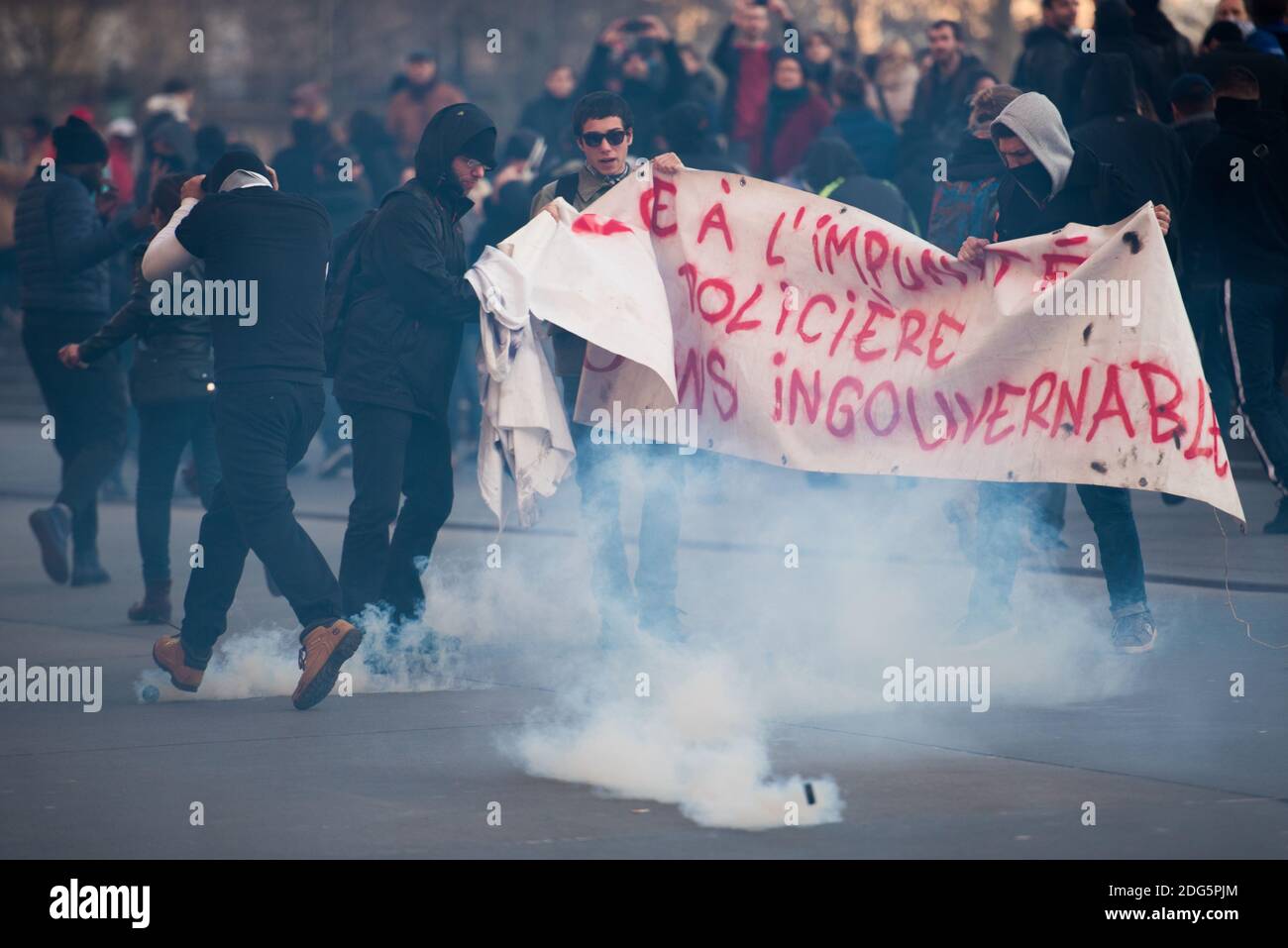 Protesters hold a banner reading "In front of police impunity, let us be  ungovernable" during a demonstration against police brutality on February  18, 2017 on the place de la Republique in Paris,