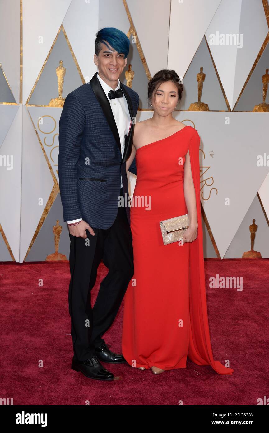 Visual effects artist Mohen Leo (L) and guest attending the 89th Annual Academy Awards at Hollywood & Highland Center on February 26, 2017 in Los Angeles, CA, USA. Stock Photo