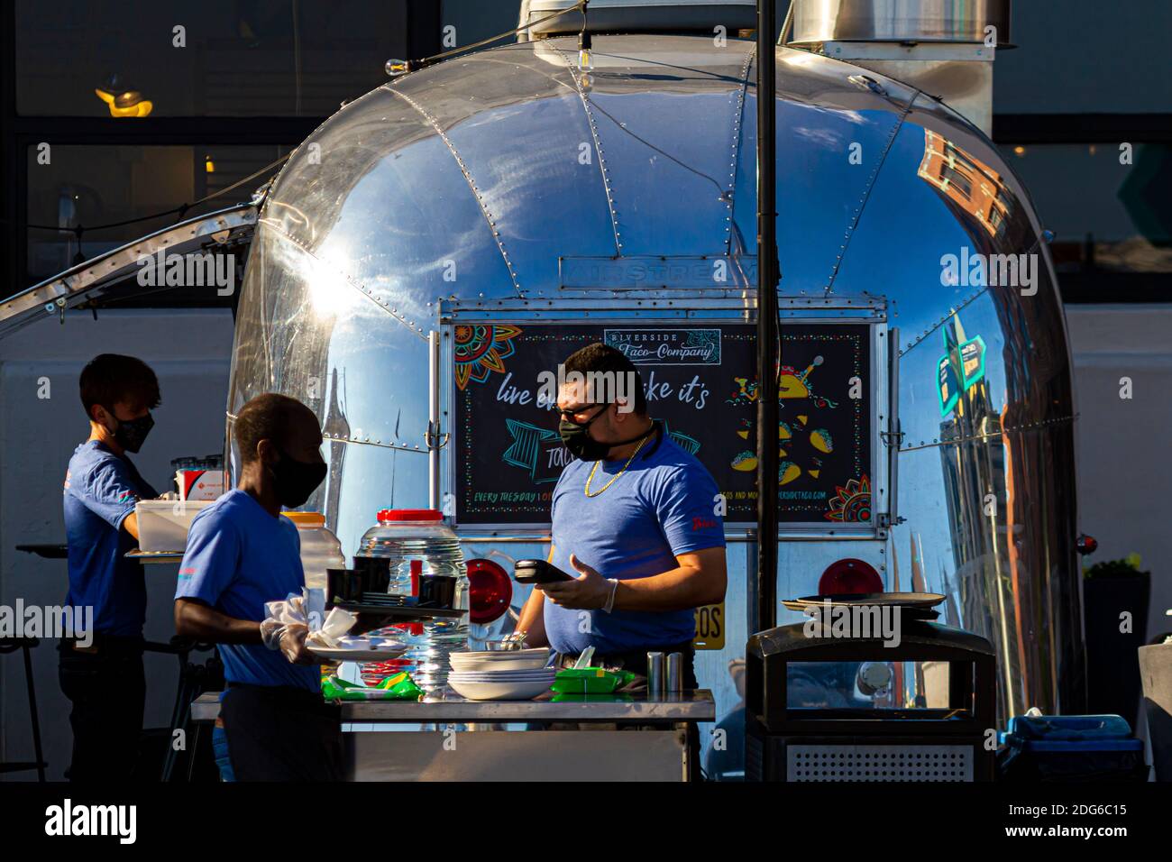 Alexandria, VA, 11-28-2020: Riverside Taco Company: A shiny metal food truck decorated as a stylish take away taco van restaurant parked in the waterf Stock Photo