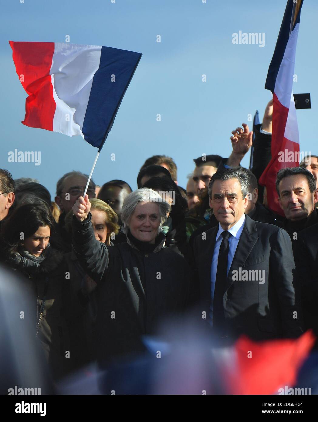 Presidential election candidate for the right-wing Les Republicains (LR) party Francois Fillon and wife Penelope Fillon and daughter Marie Fillon (L) gesture during a rally at the Place du Trocadero, in Paris, France, on March 5, 2017. Embattled French conservative Francois Fillon told supporters to never give up the fight as he strivses to stay in the presidential election race amid an expenses scandal. Fillon, who is to be charged over claims he gave his wife and children highly-paid fake parliamentary jobs, told the rain-drenched crowd he had been attacked by everyone in the campaign. Photo Stock Photo