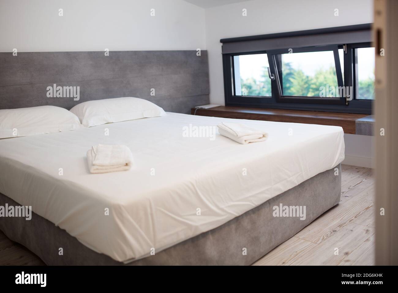 Empty hotel room with king-sized bed Stock Photo