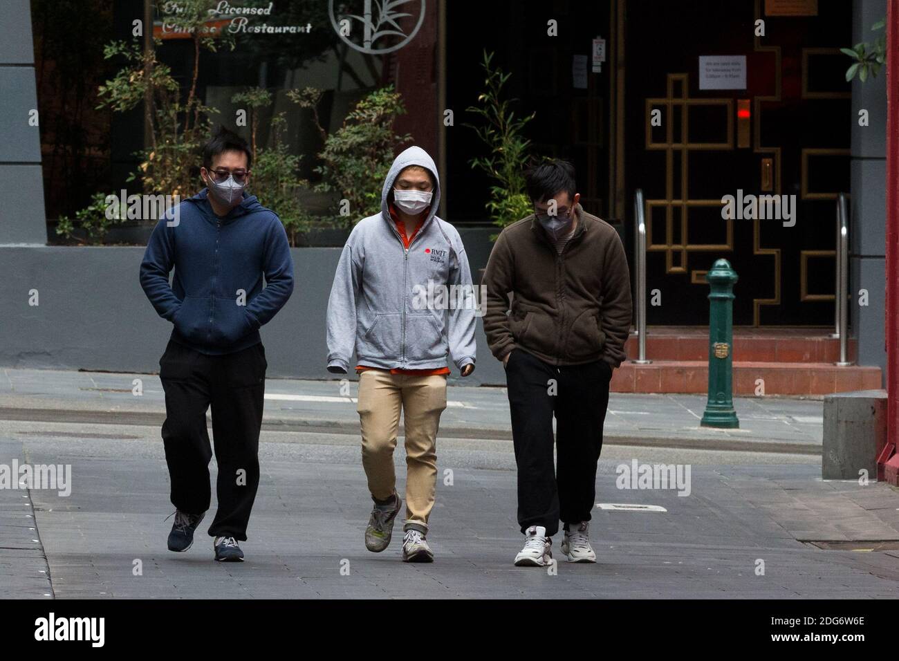 Melbourne, Australia, 24 August, 2020. Three men wearing facemasks are seen ignoring physical distancing during COVID-19 in Melbourne, Australia. Premier Daniel Andrews announced yesterday his plans to extend Victoria's State of Emergency for another 12 months giving his government and his Chief Health Officer, Brett Sutton, unprecedented powers as well as the ability to curtail democratic checks and balances. It comes as case numbers continue to fall. Responsibility for the current wave the State is experiencing rests solely on the Andrews Governments shoulders and some are saying that if th Stock Photo