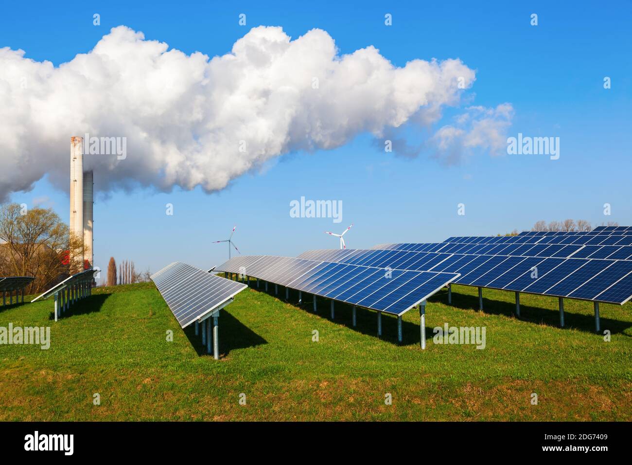 Solar collectors, wind turbines and fossil-fuel power station side by side Stock Photo