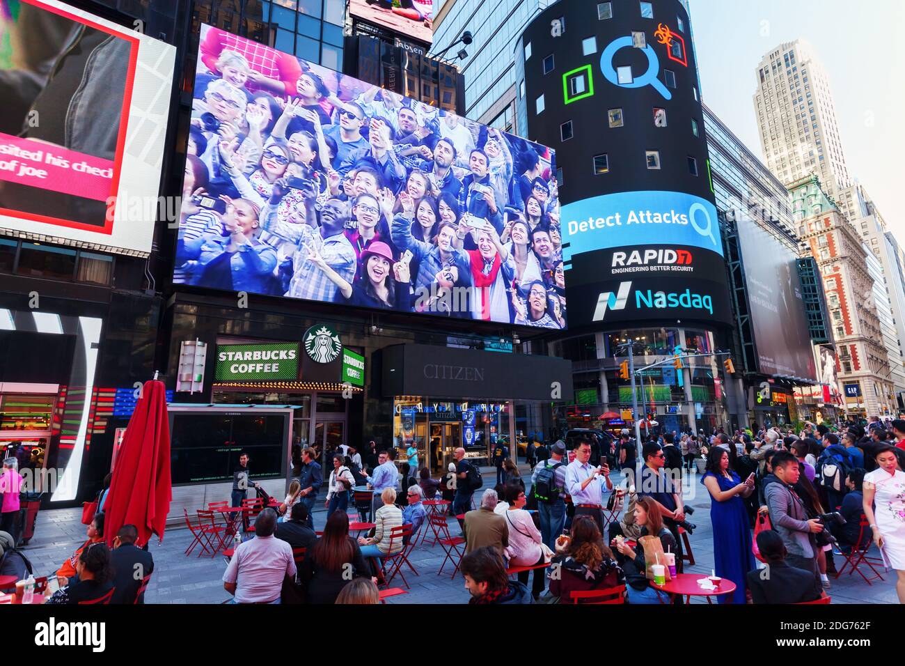 Big screen at Times Square, NYC, with the looking crowd Stock Photo