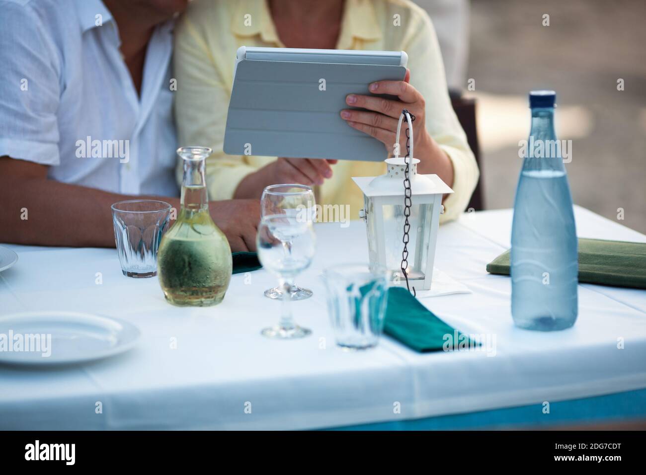 Middle-aged couple using a tablet at the table Stock Photo