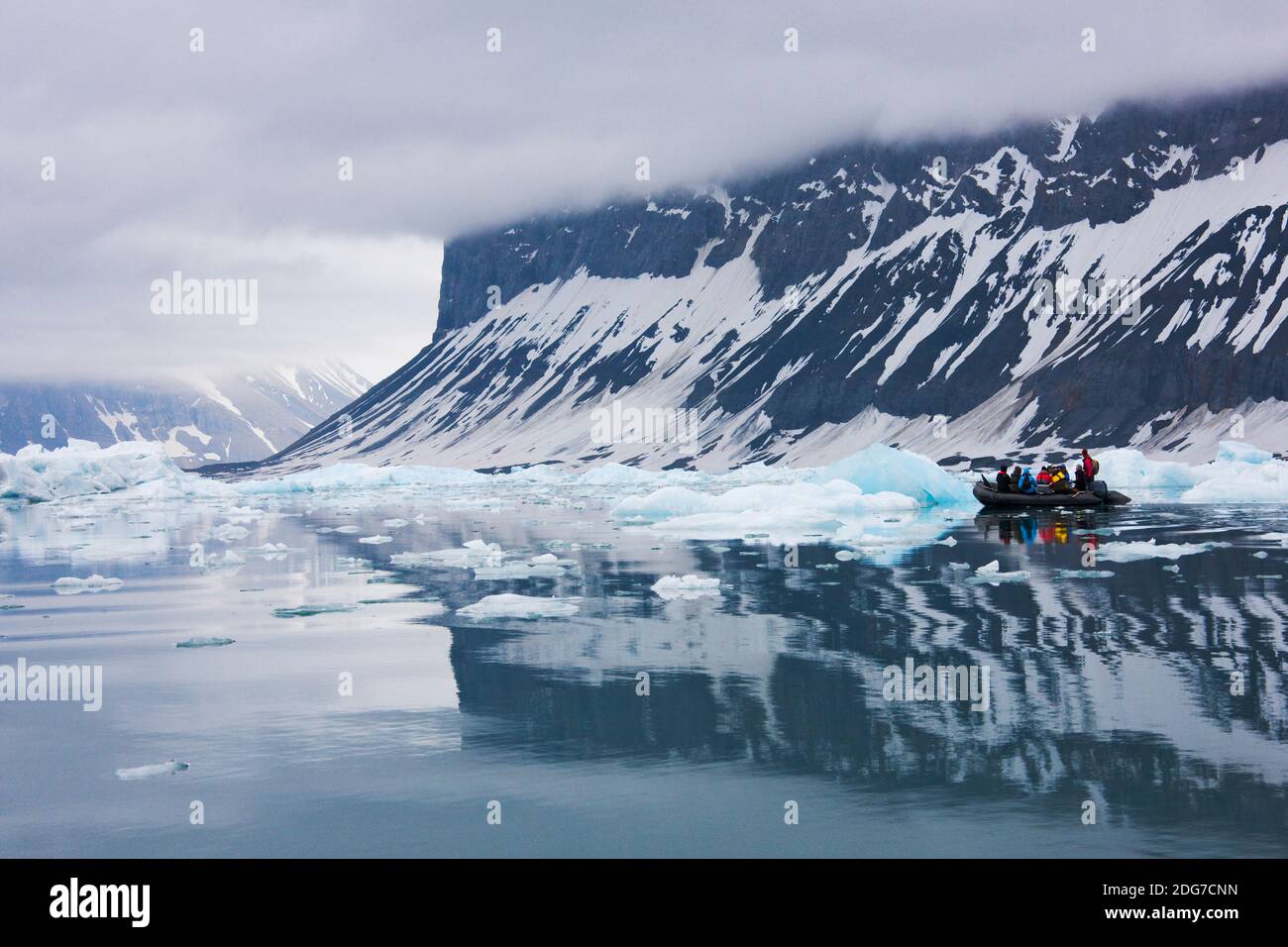 Tourists on zodiac with iceberg, Hornsund, Spitsbergen's southernmost fjord, Norway Stock Photo