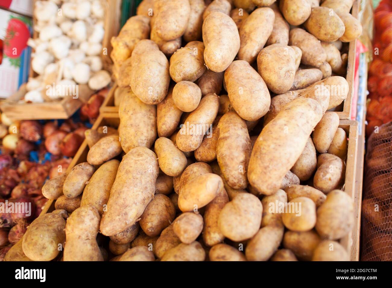 Brown Skin Potatoes Piled in Crates at Food Market Stock Photo