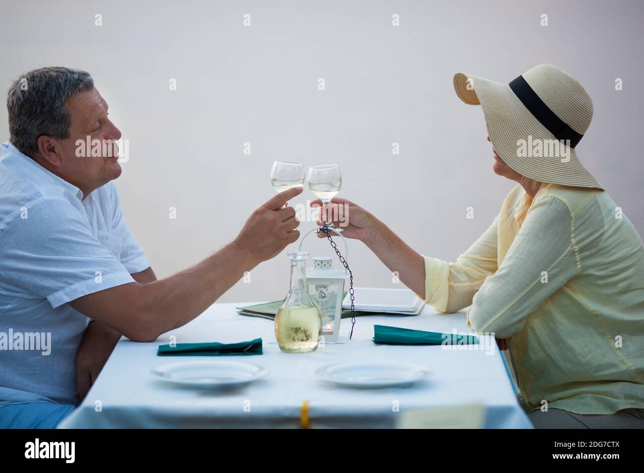 Romantic middle-aged couple toasting each other Stock Photo